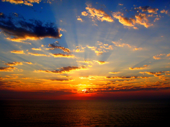spectacular ocean sunrise with clouds and sun rays